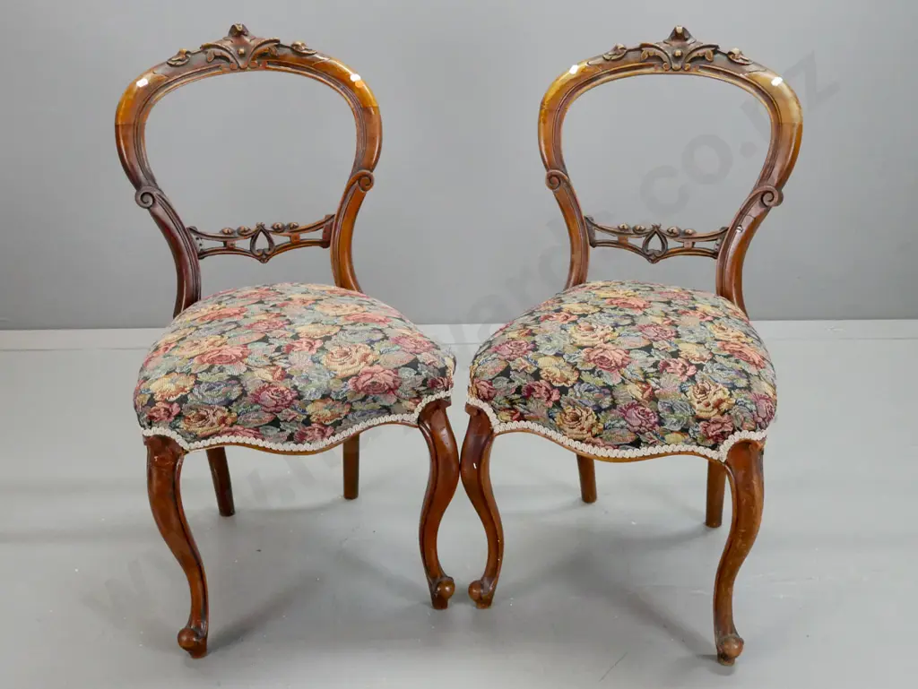 pair of Victorian walnut cab-leg balloon back chairs with carved back splat and crest, floral tapestry upholstered seats Image 1++