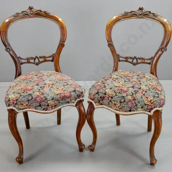 pair of Victorian walnut cab-leg balloon back chairs with carved back splat and crest, floral tapestry upholstered seats
