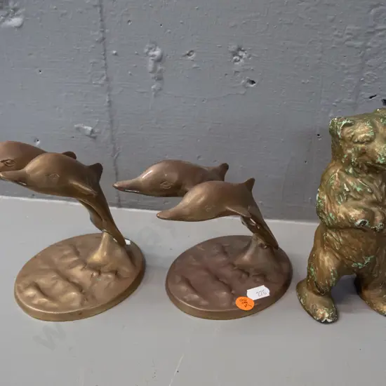 cast brass 2-piece standing bear money box and two cast brass double leaping dolphin figurines. Bear has chipped gilt