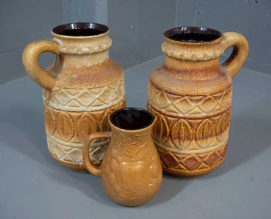 3 moulded relief pattern German pottery vases - pair of jugs H-260 W-160 and a small harvest motif jug Image 1++