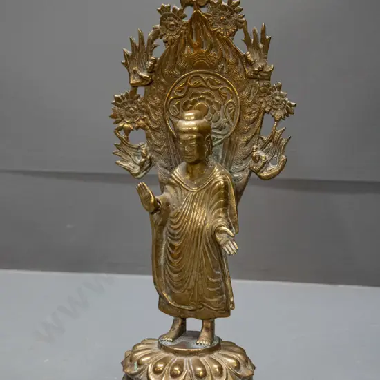 asian brass standing figure on lotus flower with pierced back piece - may have some loss to decoration on right side of