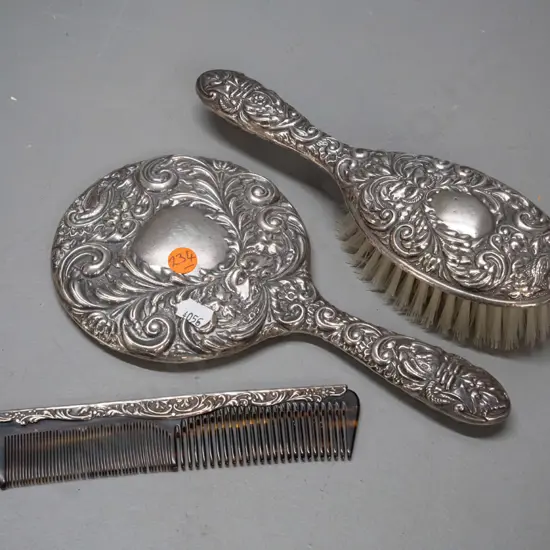 3 piece sterling silver mounted dressing table set - bevelled round mirror, brush and comb - with bird and "green man"