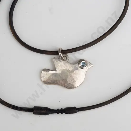 silver bird pendant on black strand stamped stg 925