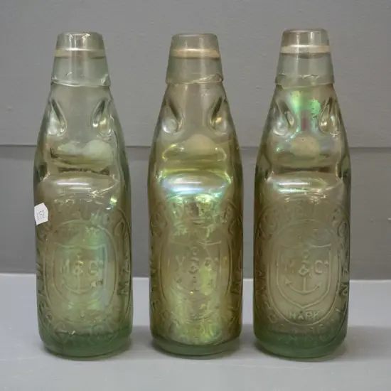 3 Moffett Invercargill marble bottles with iridescent interior coating, marked 1913 on base - H-200