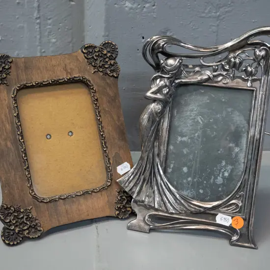2 picture frames - cast metal nouveau style figural H235 W150 & a timber and applied composite, both with backs stands,