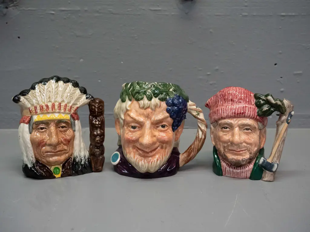 3 small to medium size Royal Doulton character jugs - North American Indian H-110, Bacchus, and Lumberjack Image 1++