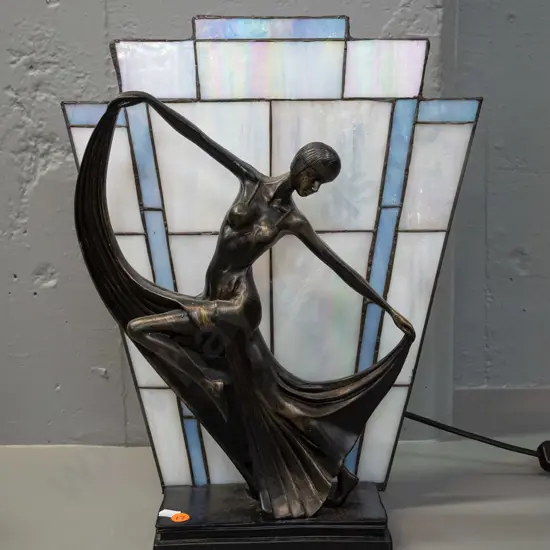 deco style table lamp with dancing woman, leadlight back panel sits in slot, base is composite with faux bronze finish
