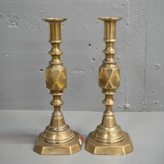 pair of Victorian brass candlesticks - marked The Diamond Princess, England. Split to base corner on one, other has