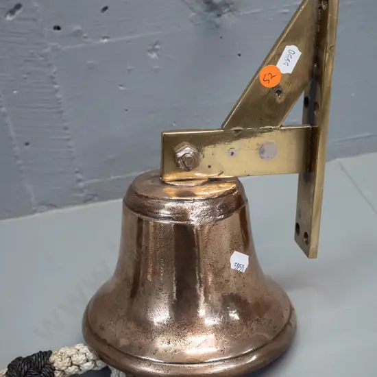 heavy bronze bell on brass mounting bracket with plaited cord pull - bell is H-100 D-150