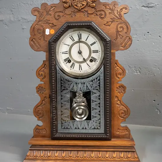 vintage Ansonia mantel clock with press-carved timber case, with key and chrome pendulum H-560 W-320