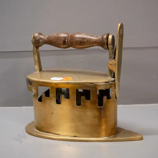 vintage brass coal iron with hinged tilting top, turned timber handle, spring clip mechanism - some discolouration to