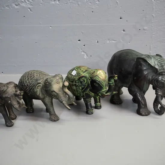 4 cast metal elephant figures with aged finish - largest is H-130 L-200