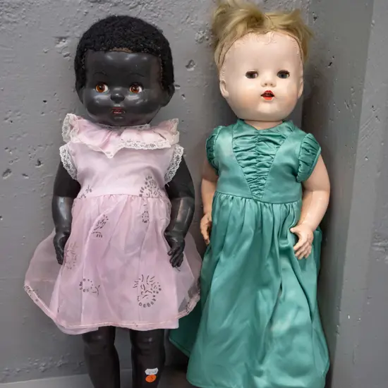 two vintage plastic-bodied dolls with dresses - one has most hair worn off, both with vintage clothing that needs
