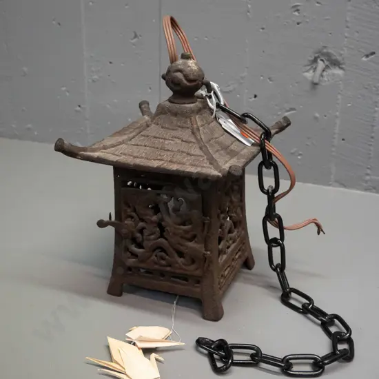 cast iron pagoda shape lamp or candle holder with hanging chain, converted to electric with light bulb fitting, cord has