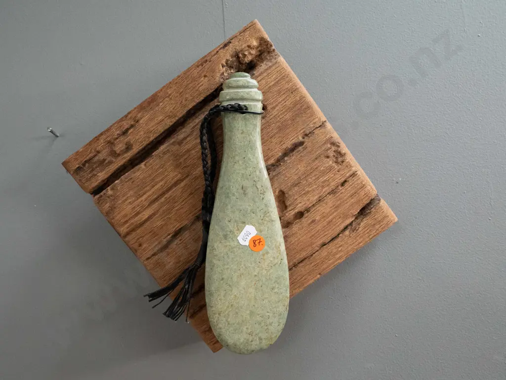 wall hanging carved green stone mere with braided cord, hanging on rustic timber piece - mere is L240, overall H290 W300 Image 1++
