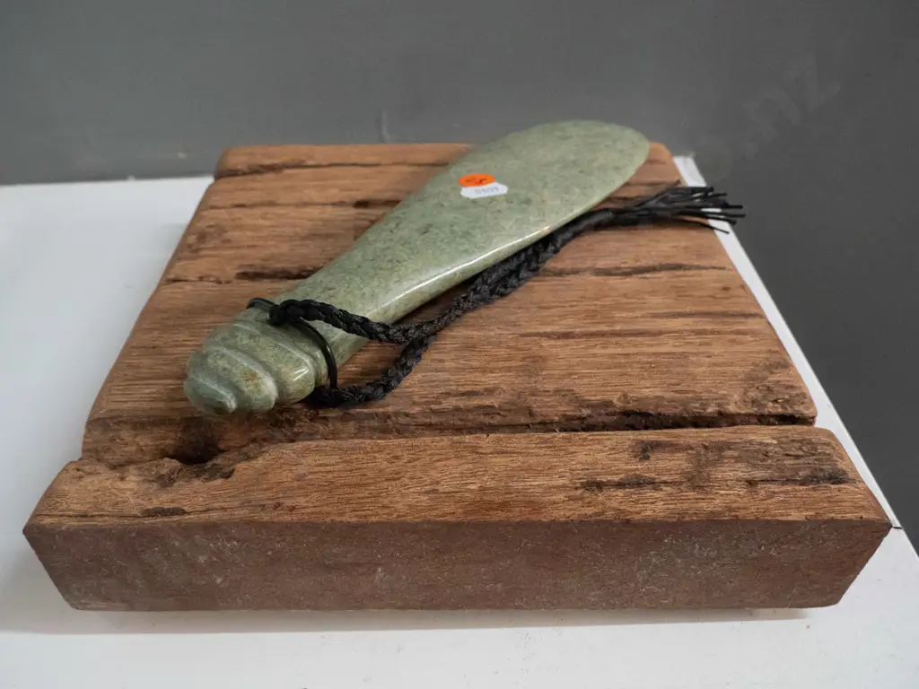 wall hanging carved green stone mere with braided cord, hanging on rustic timber piece - mere is L240, overall H290 W300 Image 1++
