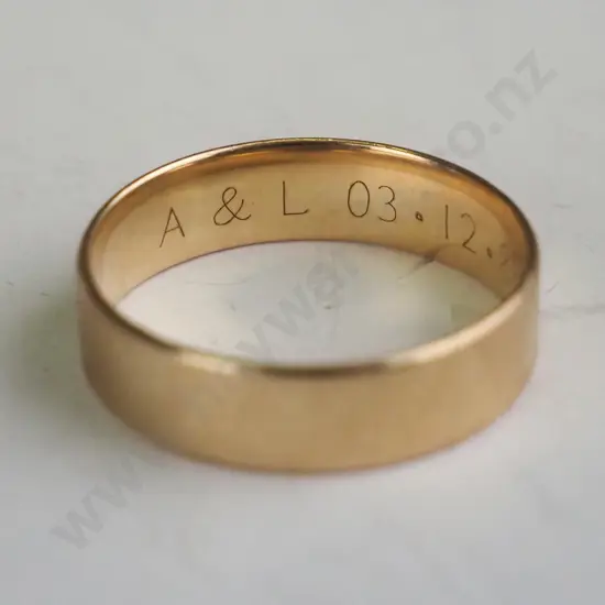 Gold wedding ring with engraved ""A&L 03.12.1988""