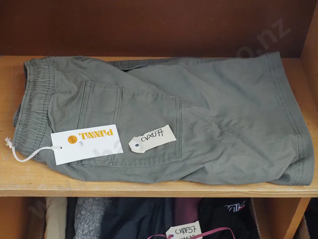 Panna shorts coloured green with a tag attached Image 1++