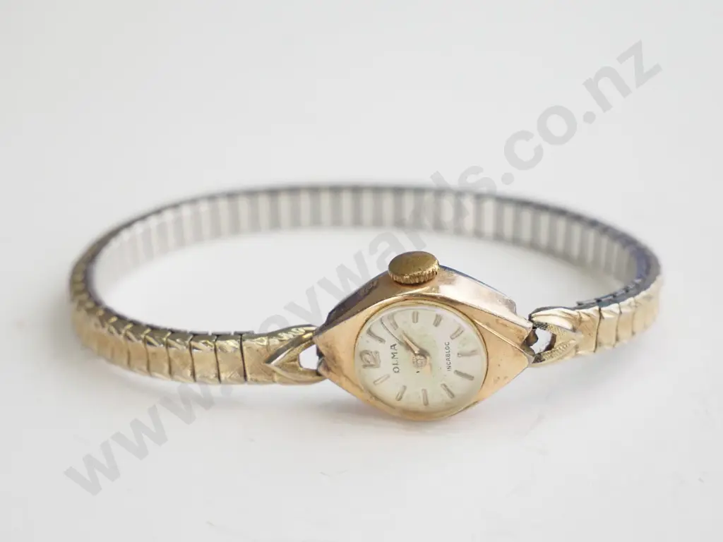Small older style gold watch - elasticated band. Image 1++