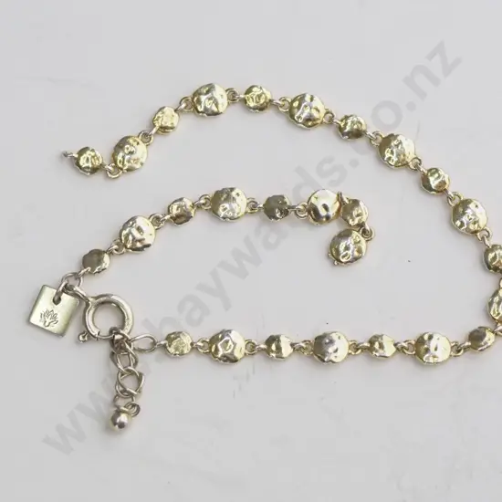 Gold linked chain bracelet with hammered disks