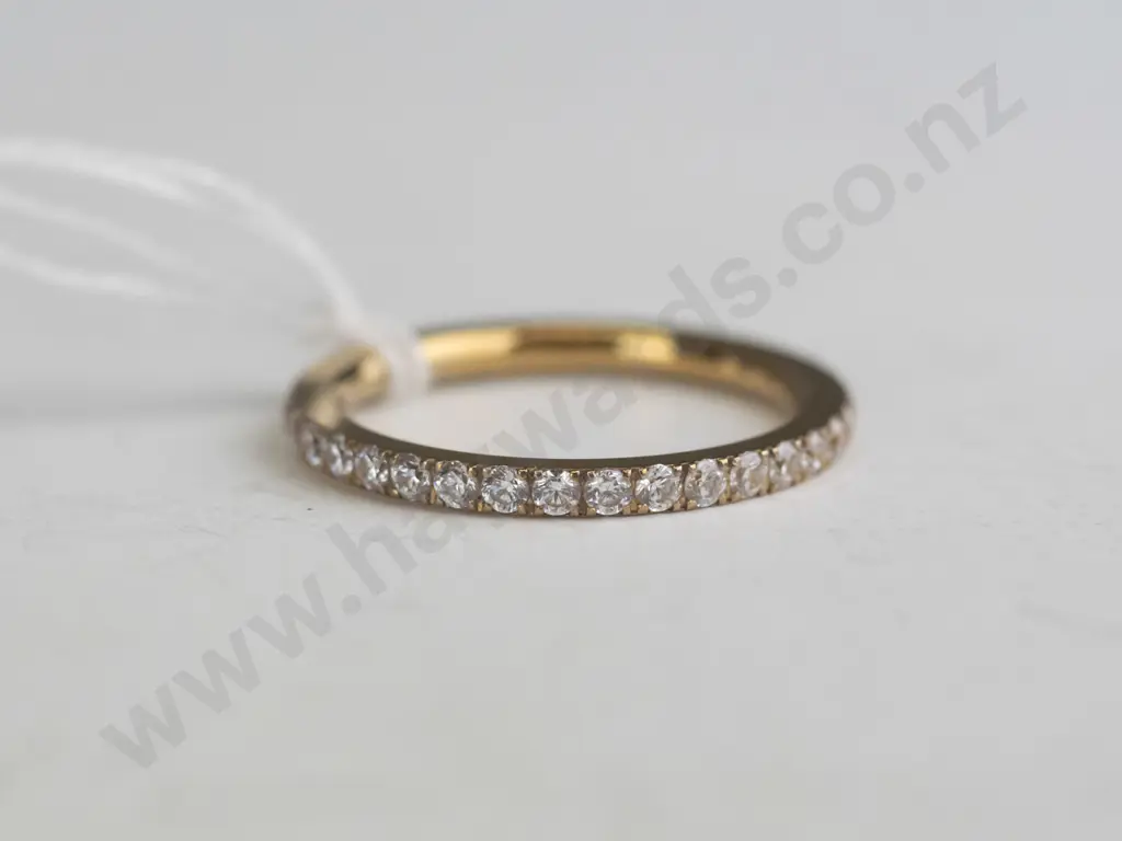 Gold banded ring with rhinestones around the entire band. Image 1++
