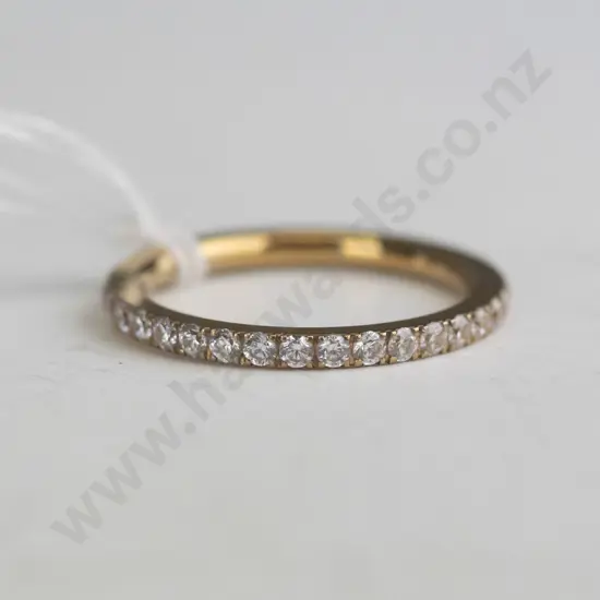 Gold banded ring with rhinestones around the entire band.