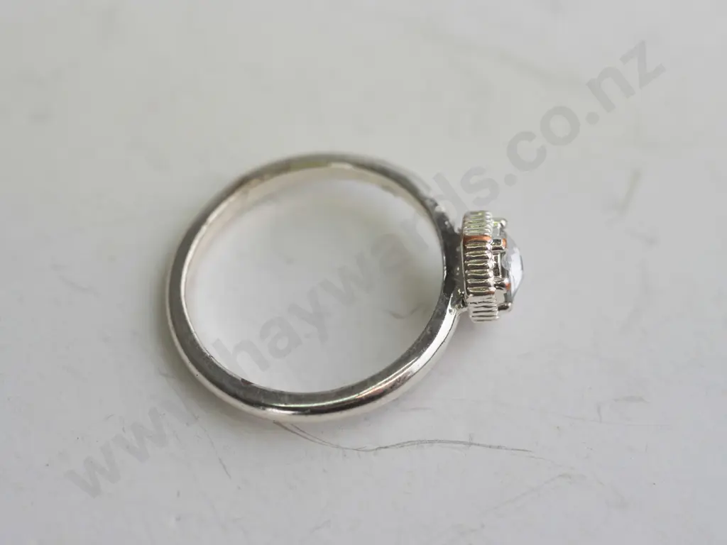 Silver coloured ring with white/silver coloured gem Image 1++
