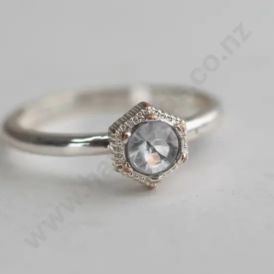 Silver coloured ring with white/silver coloured gem
