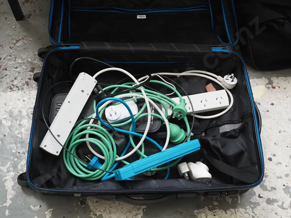 1 suitcase blue in colour  full of extension cords and chargers  Image 1++