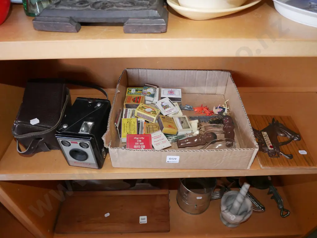 shelf; boxed brownie, matchboxes, horse thermometer Image 1++