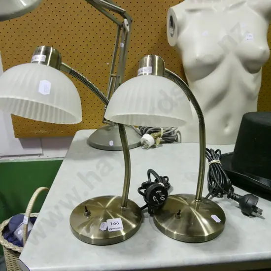 pair of brushed metal and glass bedside lamps