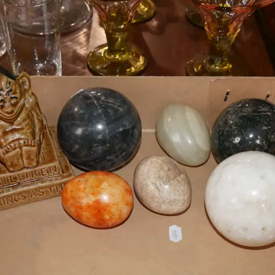 box; polished stone balls, eggs, Billiken figurine