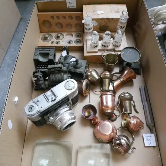 box; novelty pencil sharpeners, camera, lenses, tuning fork etc