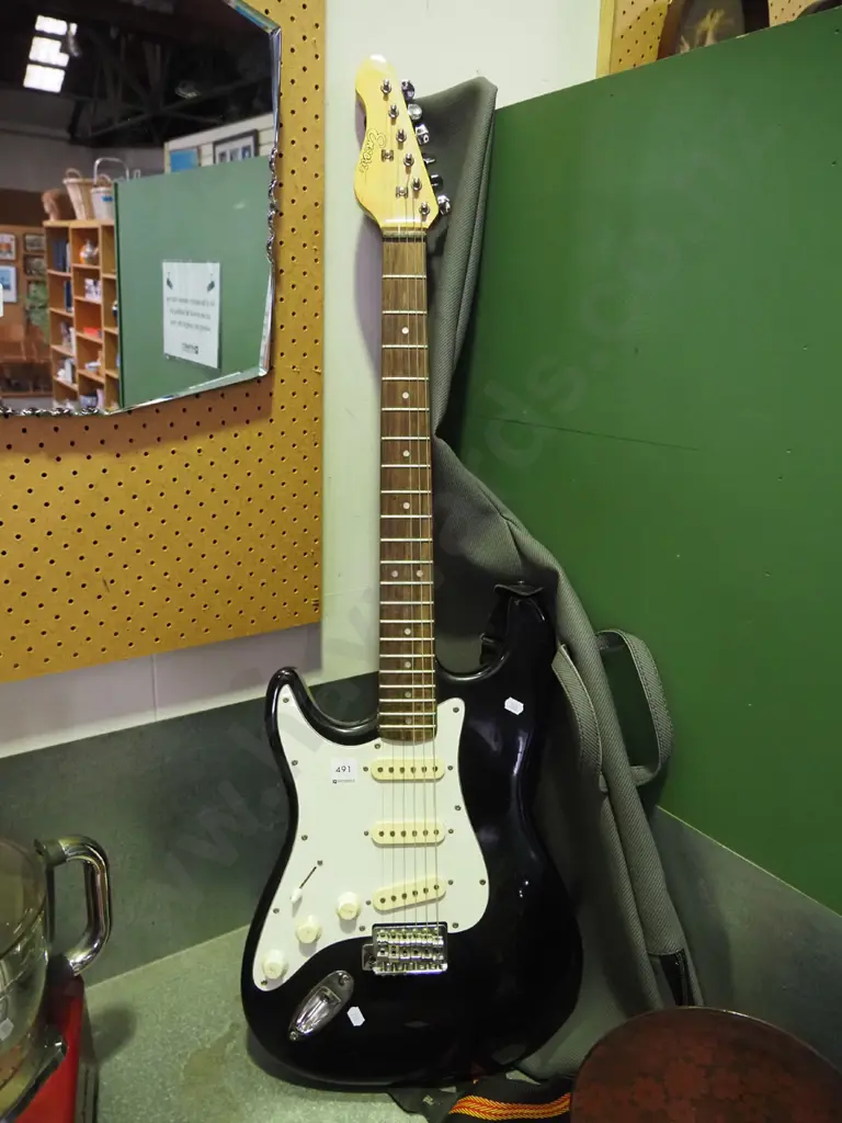 left-handed Encore electric guitar and soft carry case Image 1++