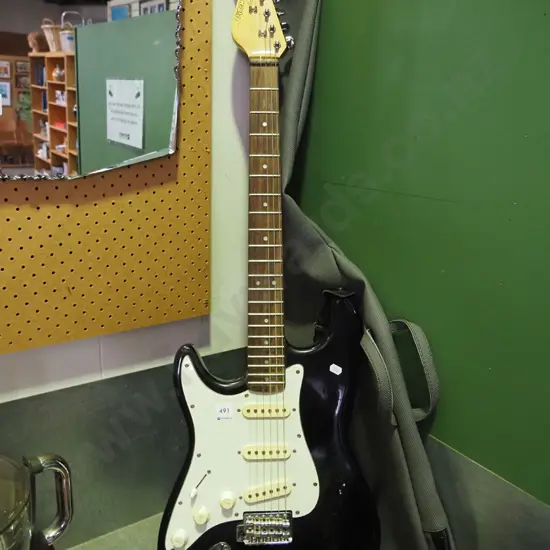 left-handed Encore electric guitar and soft carry case