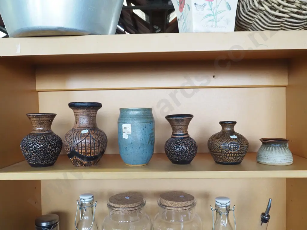 shelf of studio pottery vases and a small jug Image 1++