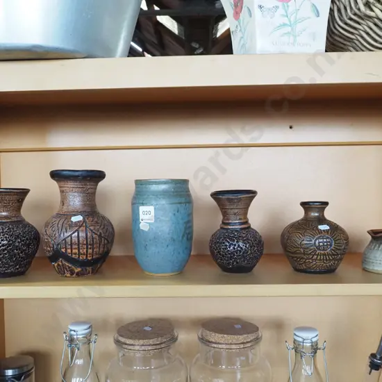 shelf of studio pottery vases and a small jug