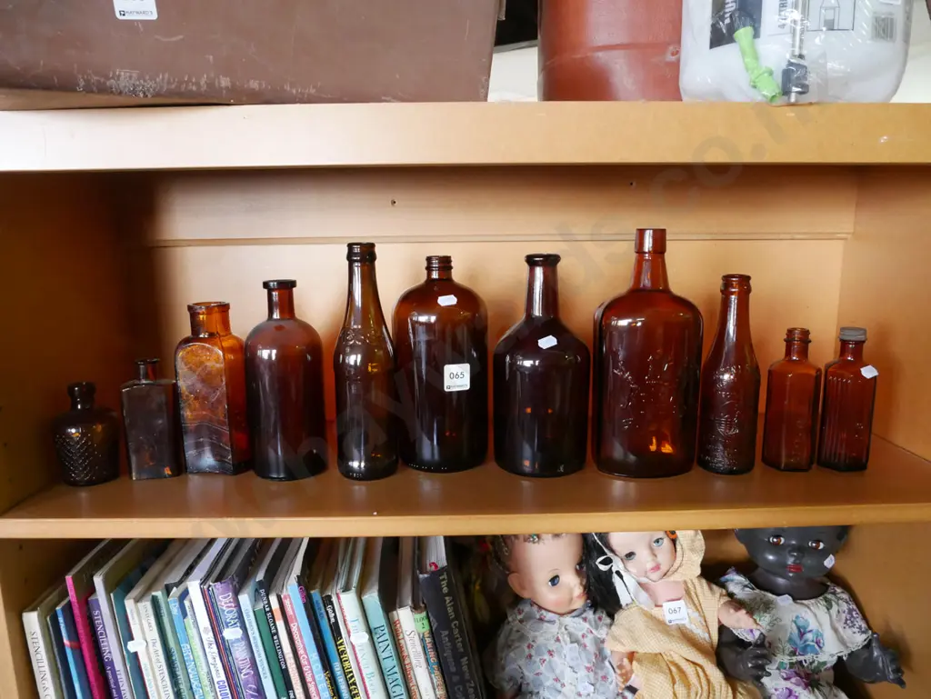 shelf of amber glass bottles Image 1++