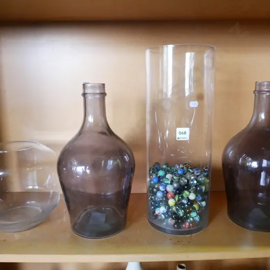 2 large glass bottles and 2 glass vases, one with marbles H-400