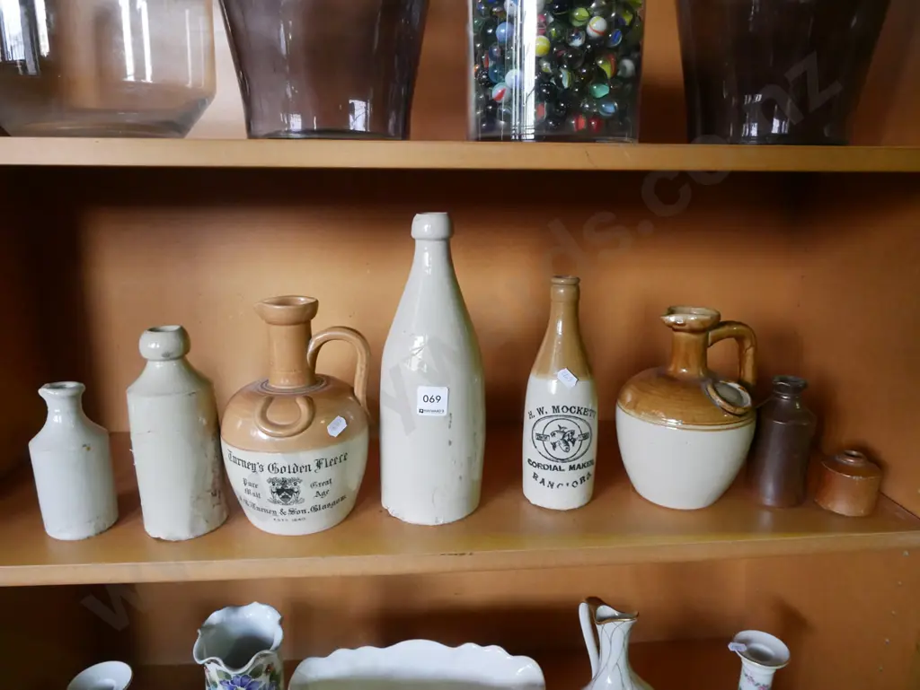 shelf of stoneware bottles (damage to some bottles) Image 1++