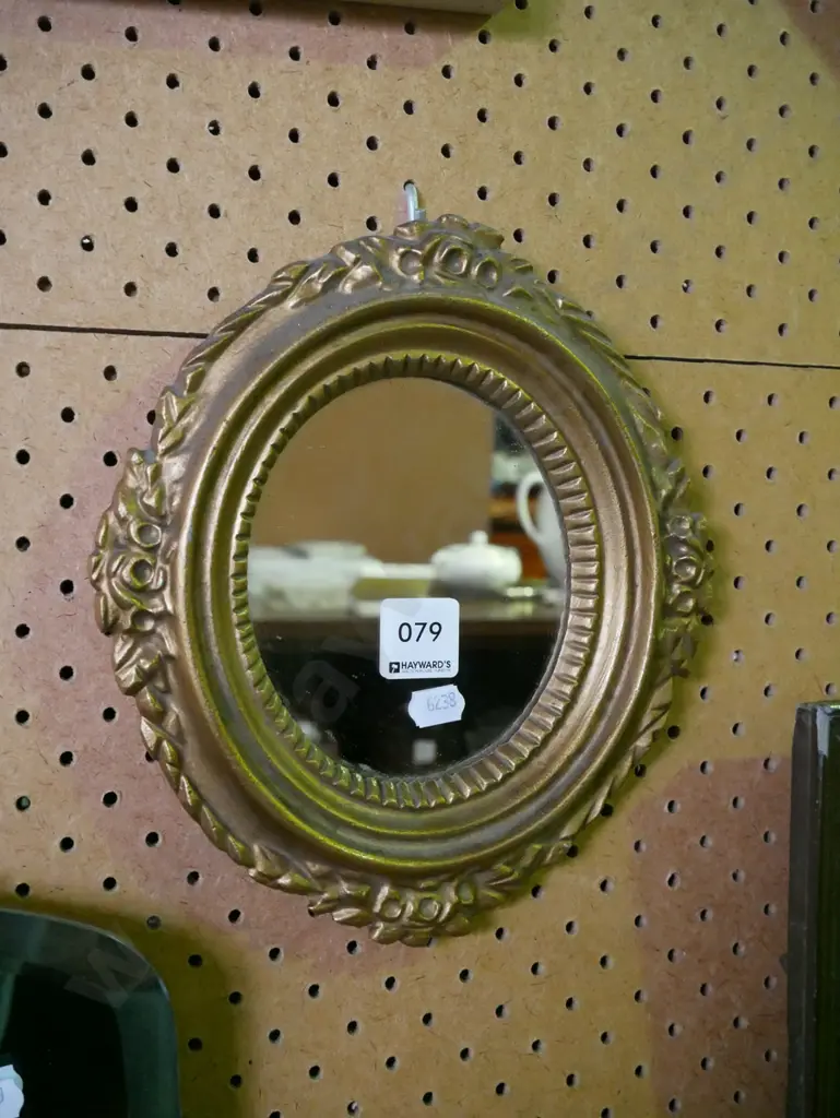 small oval gilt-framed wall mirror Image 1++