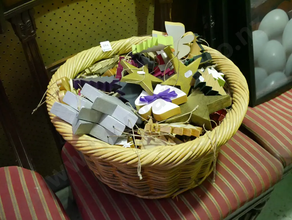 cane basket filled with wooden Christmas decorations Image 1++