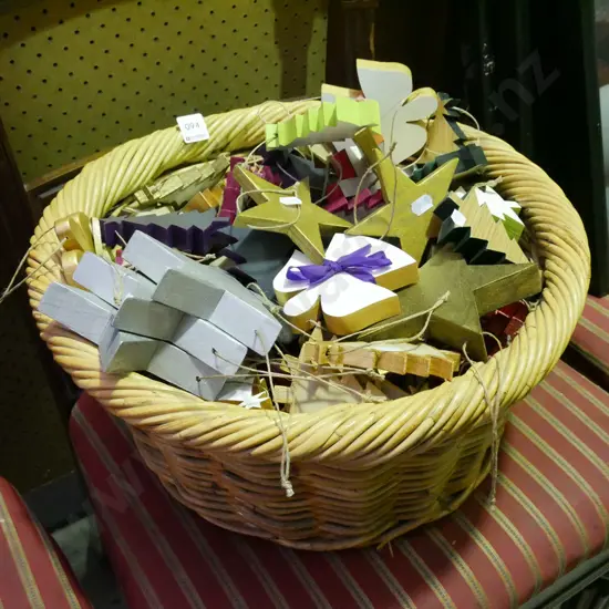 cane basket filled with wooden Christmas decorations