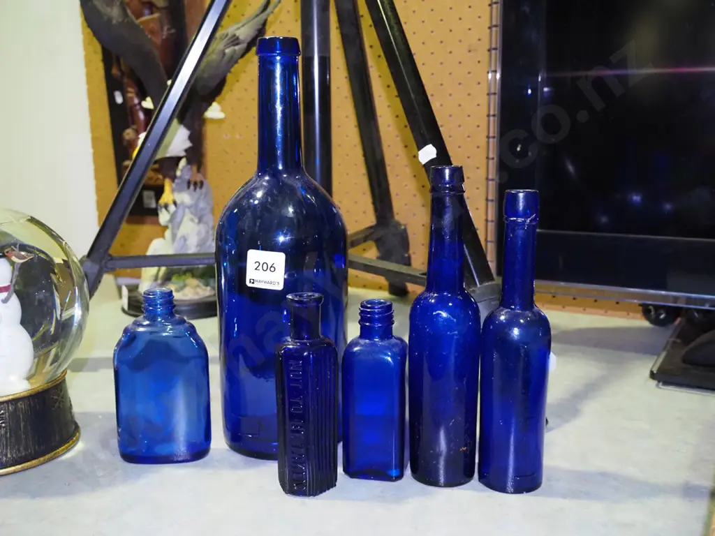 assorted blue glass bottles Tallest H-290 Image 1++
