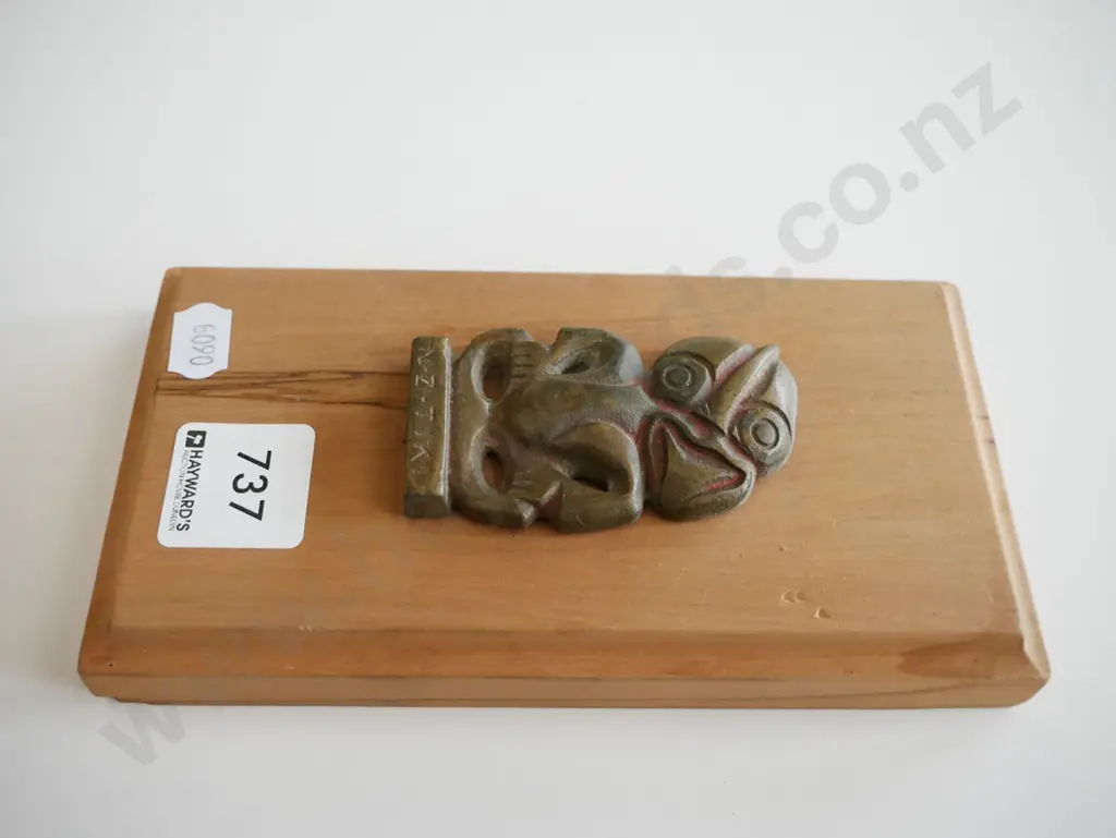 metal tiki on wooden board Image 1++
