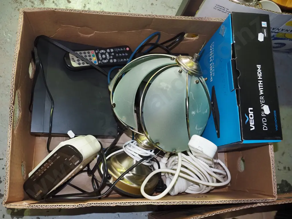 box of extension cord, bedside clock radio, dvd player, table lamp etc. Image 1++