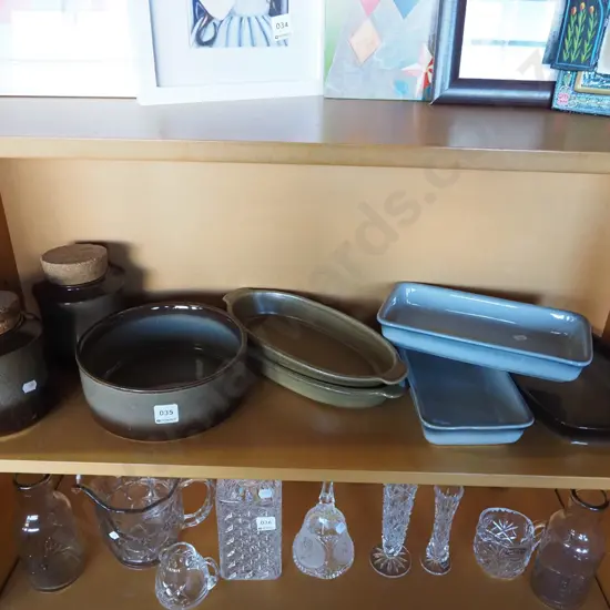 shelf of Temuka pottery; baking dish, canisters