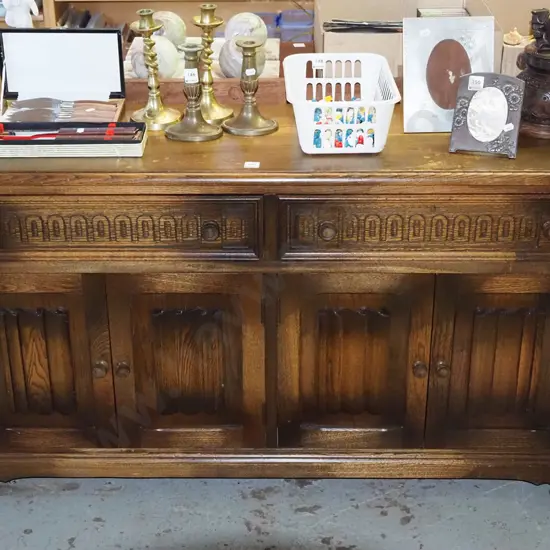 solid oak 4 door, 2 drawer sideboard with linen fold decorations to door H-700 W-1220 D-350