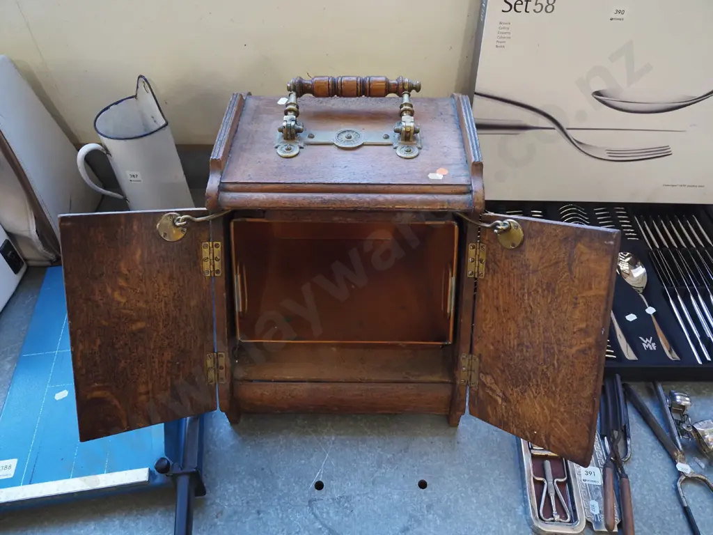vintage oak coal scuttle with brass door-opening mechanism connected to brass and timber top handle, with tin liner. Image 1++