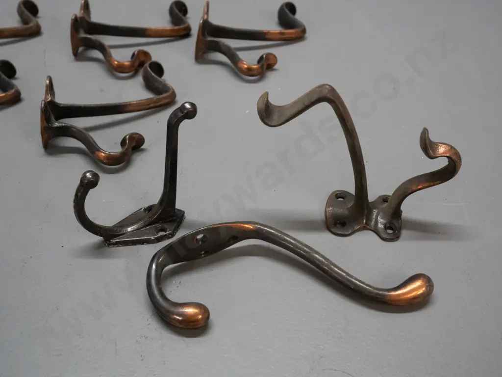 9 vintage cast metal double coat hooks - assorted shapes, some copper finish, some surface corrosion, larger are Image 1++